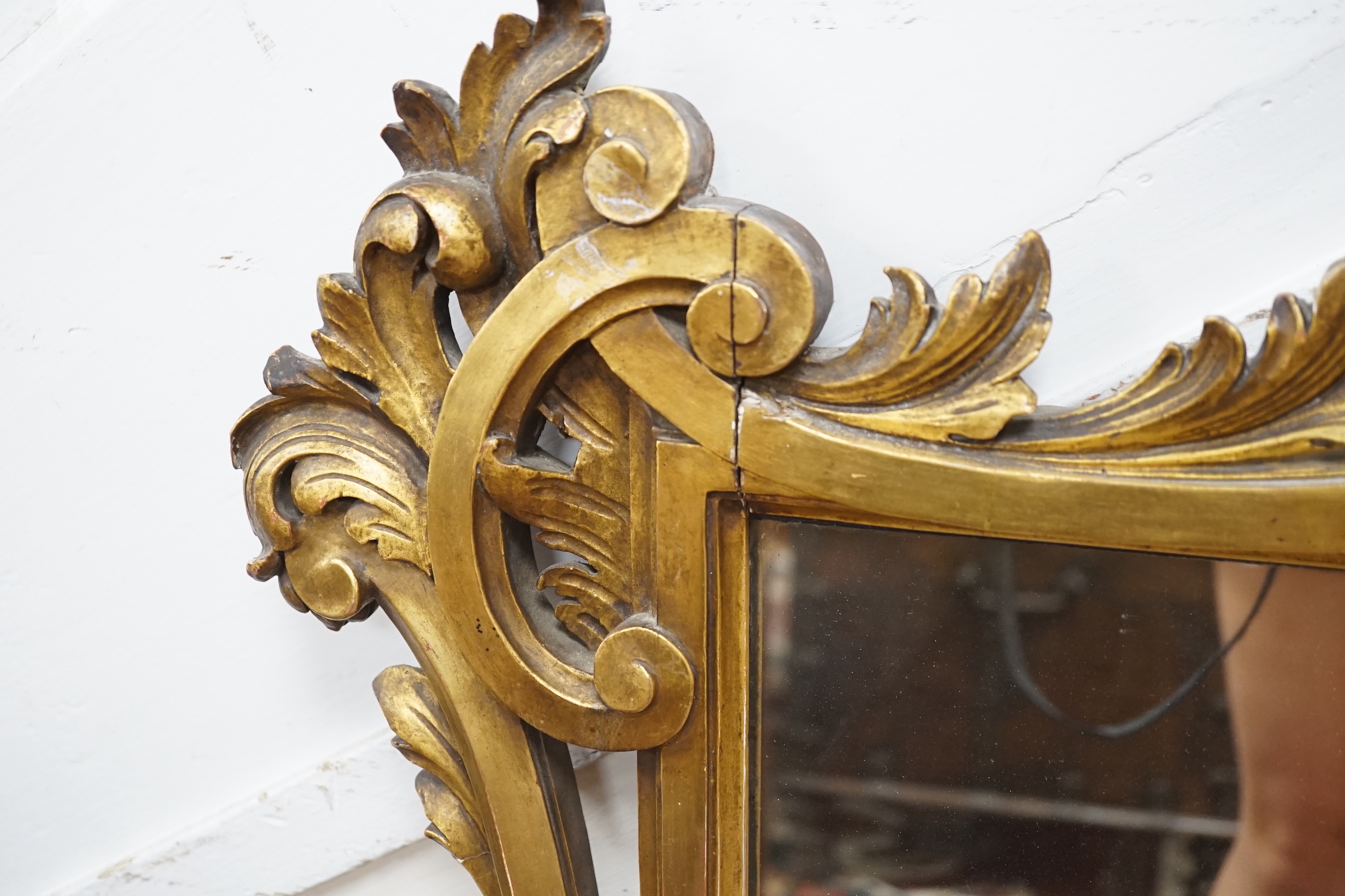 A rococo revival carved giltwood landscape mirror, width 160cm, height 113cm